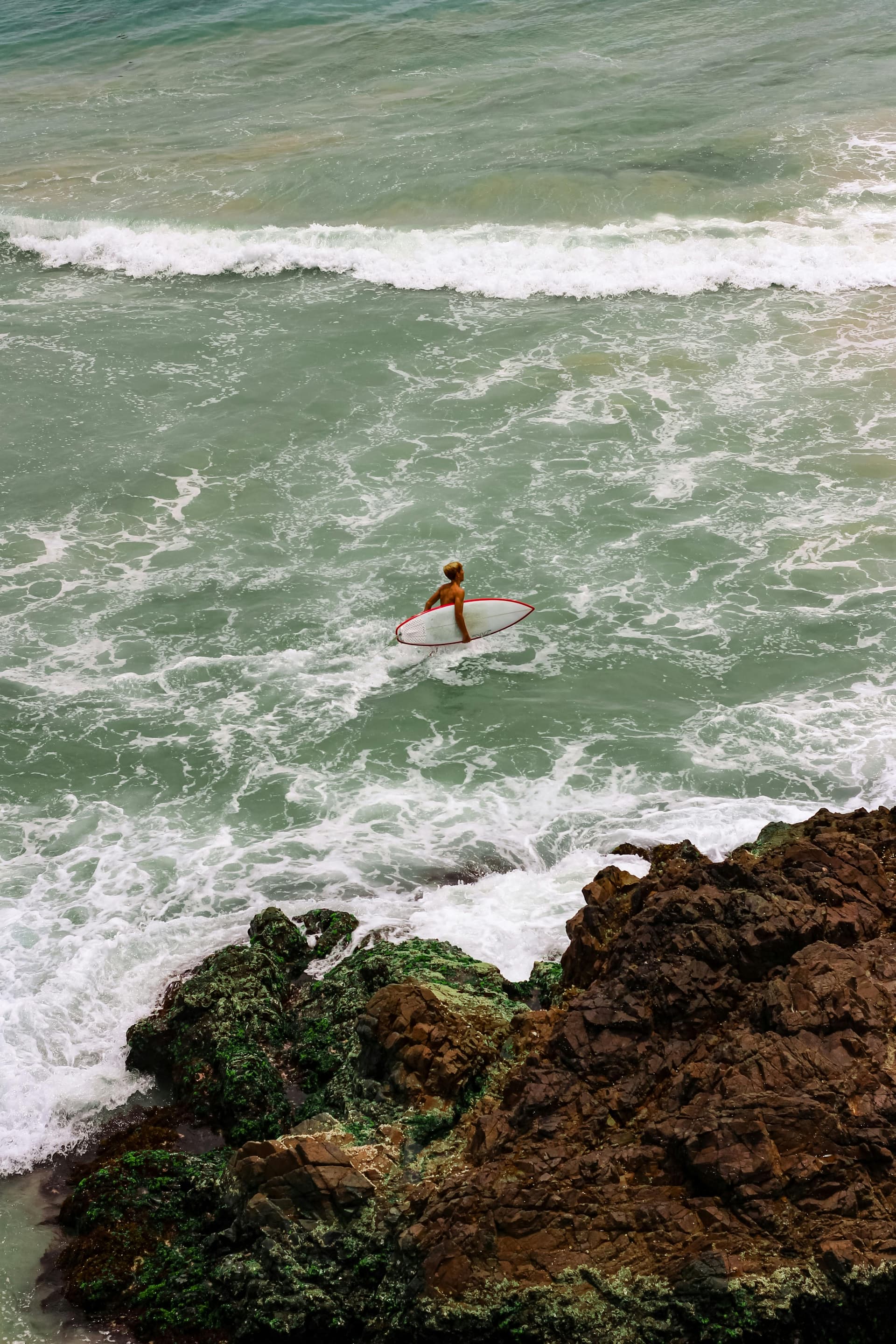Surfer entering the water at Byron Bay